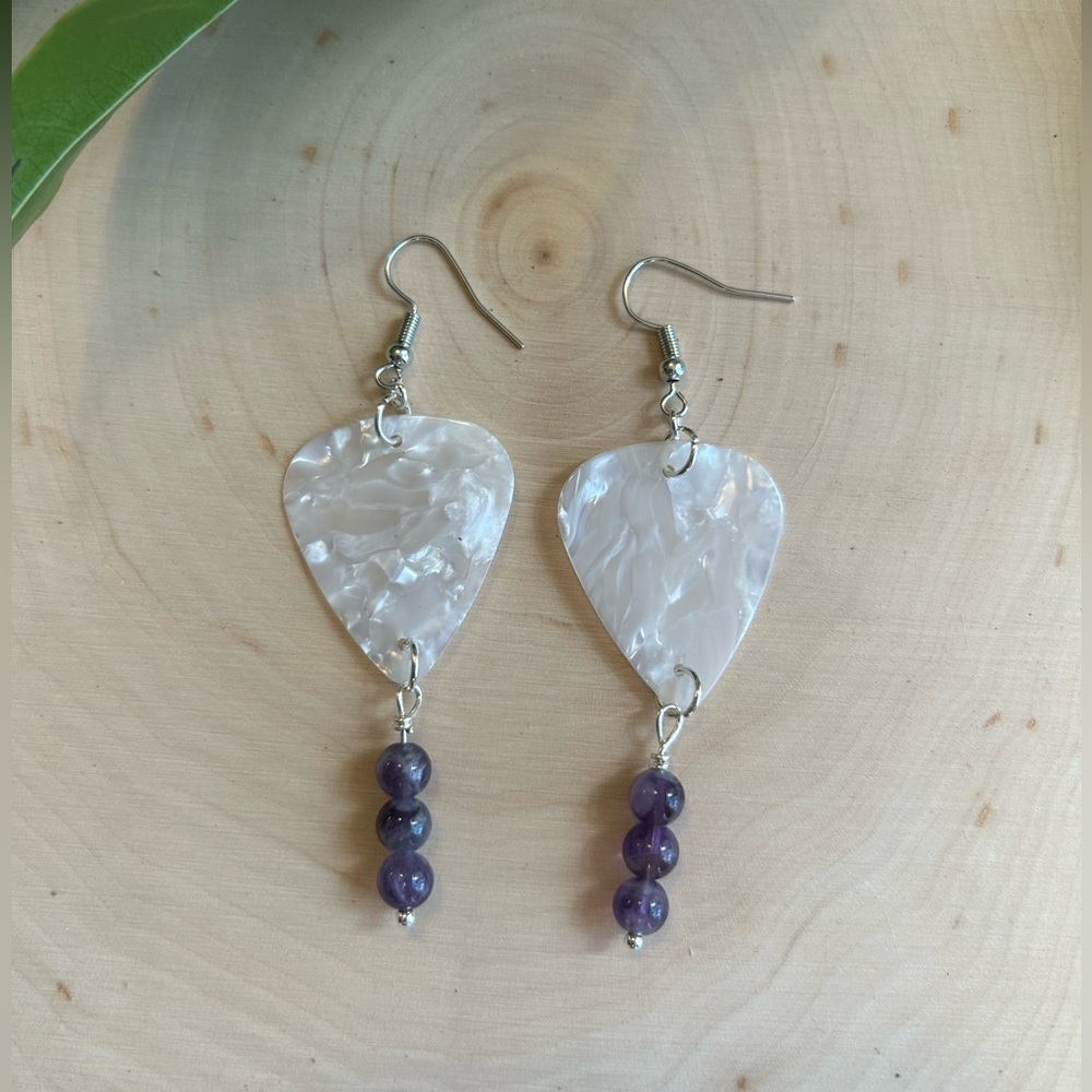 Handmade white guitar pick dangle earrings with amethyst colored accent beads